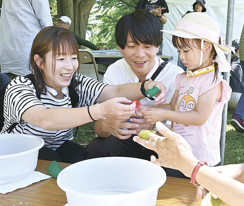 洗剤水に浸したフェルトを丸めて、球状にする親子